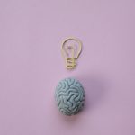 paperclip in a shape of a light bulb and a rubber eraser in a shape of a brain