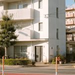 white concrete building with glass windows